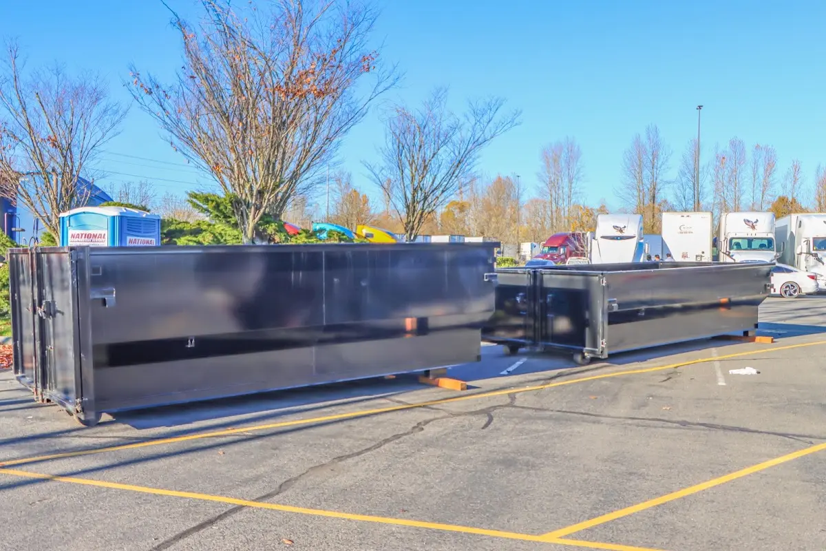 Professional dumpster rental service with roll-off container on residential driveway in Topanga